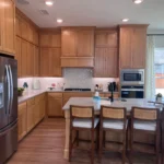 Modern kitchen featuring custom cabinetry, stainless steel appliances, and a spacious island with seating, highlighting The Perfect Cabinet Company's remodeling services.