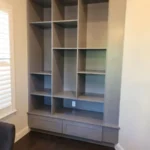 Modern cabinetry unit with open shelves and drawers, showcasing design options for office spaces by The Perfect Cabinet.