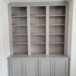 Gray cabinetry with open shelving and closed storage, showcasing modern design for office or home use.