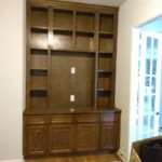 Custom wooden cabinetry with open shelves and closed storage, showcasing craftsmanship for office remodeling, featured in The Perfect Cabinet gallery.