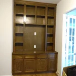 Custom wooden cabinetry with open shelves and closed storage, featured in an office setting, showcasing The Perfect Cabinet's craftsmanship.