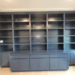 Modern blue cabinetry with open shelves and closed storage, showcasing craftsmanship for office remodeling by The Perfect Cabinet.