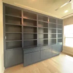 Modern dark cabinetry with open shelves and closed storage, designed for office space, showcasing craftsmanship by The Perfect Cabinet.