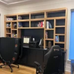Office setup featuring cabinetry with open shelves and a black desk, showcasing organization and modern design elements for The Perfect Cabinet's gallery.