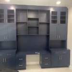 Modern blue cabinetry with multiple shelves and drawers, designed for office use, showcasing The Perfect Cabinet's craftsmanship.