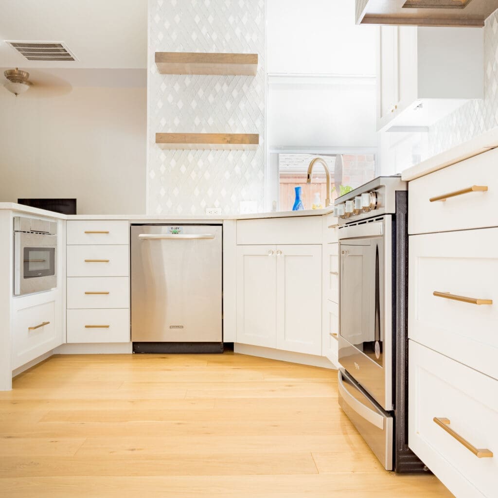 Modern kitchen with custom cabinetry, stainless steel appliances, and elegant wood accents, showcasing a bright and airy design ideal for home remodeling inspiration.