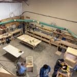 Workshop interior with woodworking tools and materials, showcasing custom cabinetry production at The Perfect Cabinet Shop.