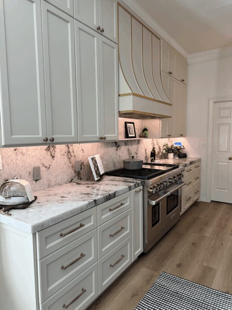 Modern kitchen design featuring custom cabinetry, marble countertops, stainless steel appliances, and stylish accents, illustrating a sophisticated open-concept space ideal for Dallas home remodeling.